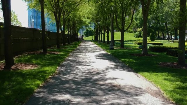 Chicago downtown park pathway during a mid summer afternoon.  a very scenic quite garden as the leaves slowly fall from the trees creating a scenic green flow.  