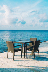 empty outdoor patio deck and chair with blue ocean in Maldives