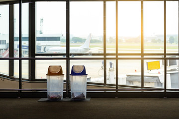 Trash in airport terminal. Recycle bin for waste management. 