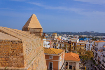 view of an agglomeration of houses in Ibiza (Spain) near the bulwark of Saint Luciat that is a fortified defensive enclosure that surrounds the medieval city of Ibiza 