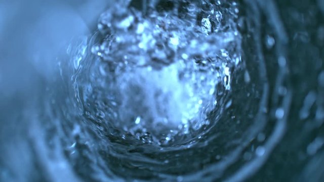 Super Slow Motion Shot of Pouring Water into Water Vortex at 1000 fps.