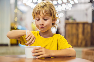 Boy eating ice cream in a cafe