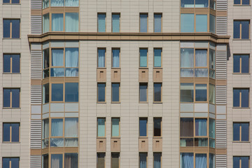 Fototapeta na wymiar Facade of a multi-storey apartment building against the blue sky