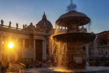 Reflection of the sunset in the fountain of the Vatican.