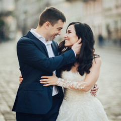 Lovely wedding couple kissing in the city.