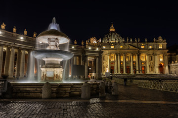 Fototapeta na wymiar Fountain at night on the Vatican Square in Rome.