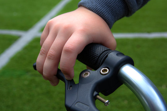 Close-up of biker hand pushing brake lever