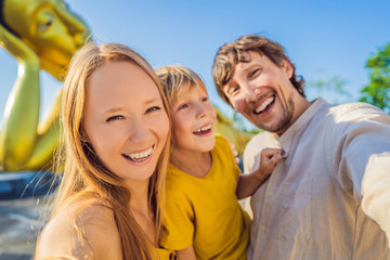 Happy tourists mother, father and son on background ofLying Buddha statue