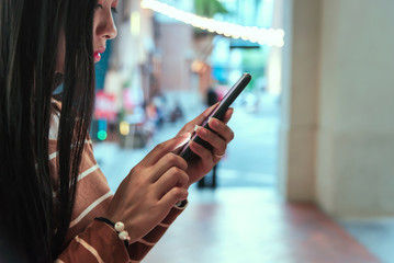 Young girl holding phone new app technology in the city.