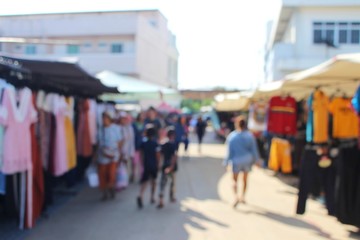 Many people are walking in the morning market to take blurred photos