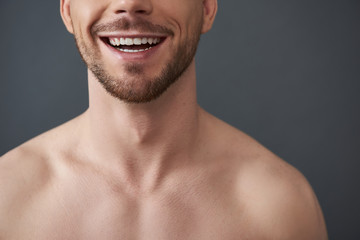 Cropped photo of naked attractive Caucasian guy posing for camera