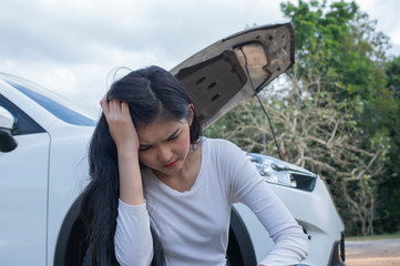 Asian women the car is broken road. Open the bonnet, check engine - Image