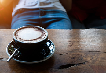 Close up black coffee cup with latte.