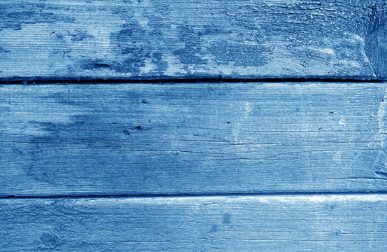 Weathered wooden painted wall in navy blue tone.