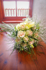 Bridal rose bouquet on a wooden table