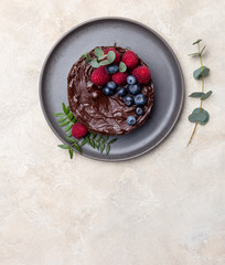 Free space with chocolate cake on light background