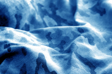 Old camouflage cloth with blur effect in navy blue tone. © pavelalexeev
