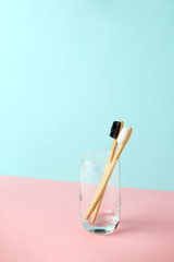 Zero-waste, biodegradable bamboo toothbrush and glass modern 3d background, minimal eco-friendly concept