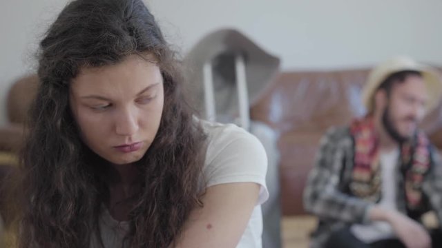 Close up portrait of sad angry woman and happy man in summer hat on the background
