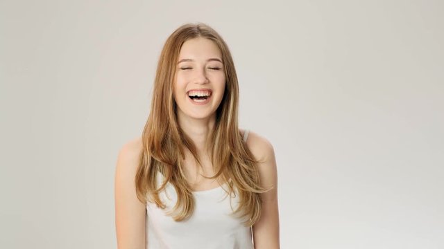 Young pretty exited laughing woman with funny face in slow motion