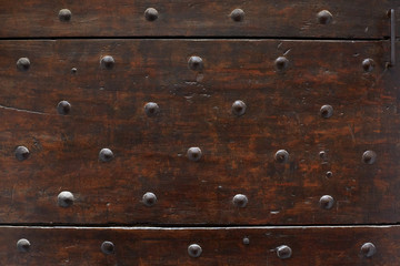 Old wooden door with nails texture background