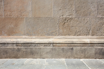 Old stone wall with molding and floor background in sunlight, nobody