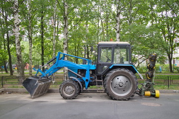 Fototapeta premium tractor for grass mowing in the city