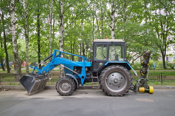 tractor for grass mowing in the city