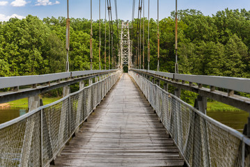 Obraz premium View of the pedestrian bridge through the Neman River in the city Mosty, Republic of Belarus