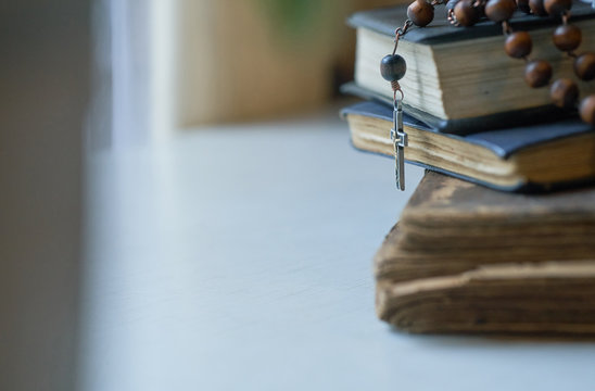 The rosary beads on Catholic Church liturgy books.