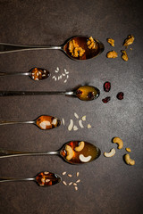 Food Art.  Spoons full of honey with seeds and nuts