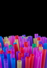 Mixed vivid color of straw sticks. Isolated concept on black background