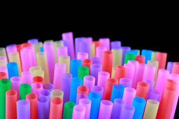 Mixed vivid color of straw sticks. Isolated concept on black background