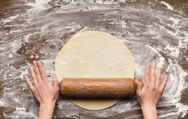 Chef Rolling Dough For Pizza On Table