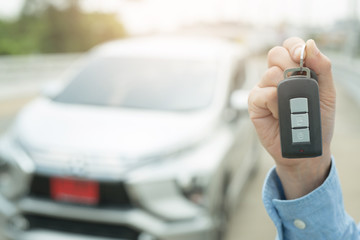  Businessmen holding a new red car key Car business concept