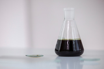 Scientist tearing the CBD oil with a precise dropper from a bowl into a tube