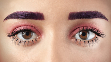 Young woman with dyed eyebrows and creative makeup, closeup