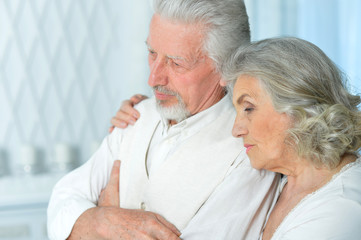 Close-up portrait of sad senior couple posing