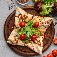 Closed Pizza Decorated With Cherry Tomatoes, Top View