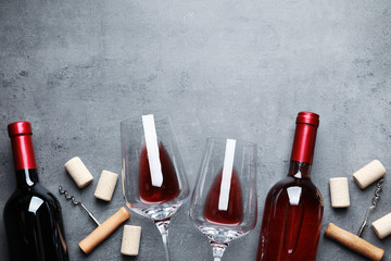 Flat lay composition with different wines on grey background. Space for text