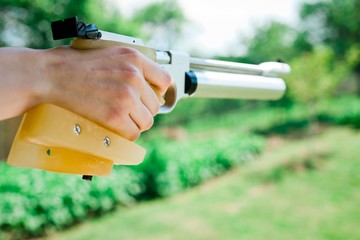 Detail on hand holding custom made grip of sport air pistol.