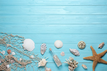 Flat lay composition with seashells and space for text on wooden background
