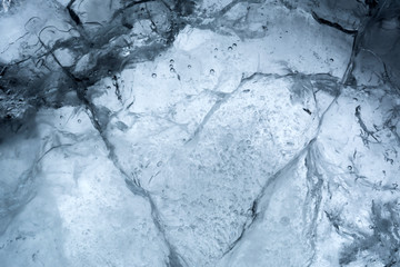 Ice texture background macro close up in sunlight. Beautiful abstract patterns of frozen water.
