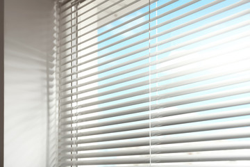 Closeup view of window with horizontal blinds