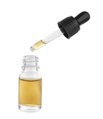 Little bottle with essential oil and dropper on white background