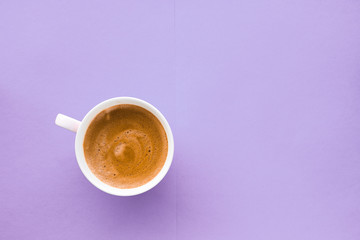 Coffee cup on purple background, top view flatlay