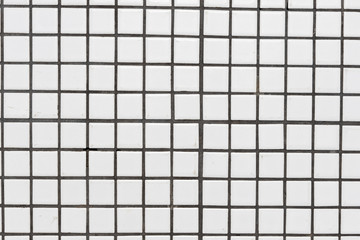 White dirty ceramic tiles wall or floor for background texture.