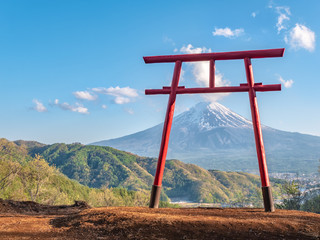 Red torii of Chureito temple with Mountain Fuji as background.