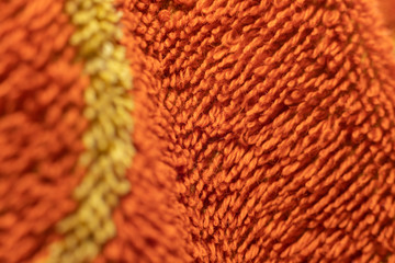 Macro filament on the surface of the orange towel.