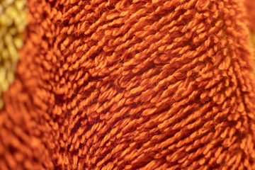 Macro filament on the surface of the orange towel.